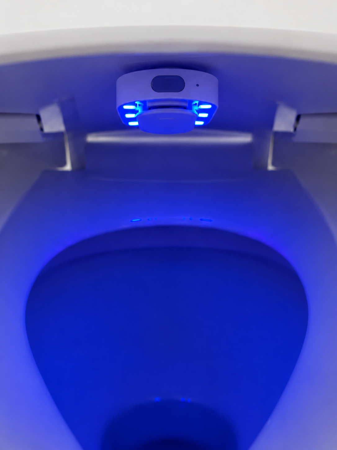 Azuremist UV-C device running a blue disinfection cycle inside a toilet bowl